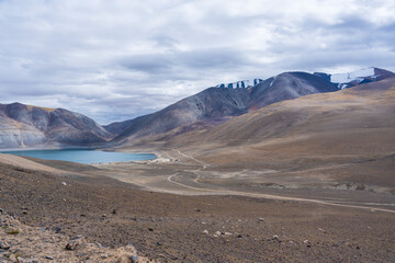 Fototapeta na wymiar Mirpal Tso - Lake Ladakh, an isolated, unexplored freshwater lake surrounded by white sand and mountains