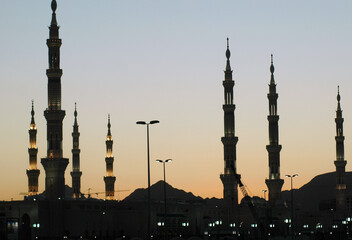 Fototapeta na wymiar Mosque at sunset, Minarets of Masjid an-Nabawi, Evening time. Medina, Saudi Arabia.