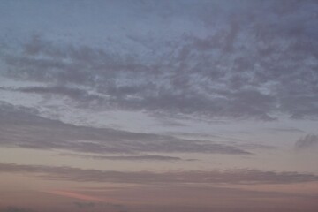 Twilight sunset sky. Nature background. Soft golden clouds. Sunrise early morning. Dramatic pastel panorama. Aerial view. Abstract landscape texture