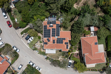 photovoltaic solar panels installed on the roof of residential homes in the village. harnessing the...