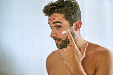 Man, face and cream for skincare, beauty and sunscreen at home with mockup for morning routine,...