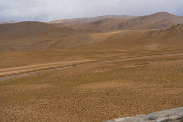 Landscape of Desert mountains against clouds sky at the way from Pangong Lake to Tso Moriri, Leh, Ladakh, Jammu and Kashmir, India