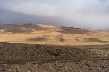Landscape of Desert mountains against clouds sky at the way from Pangong Lake to Tso Moriri, Leh, Ladakh, Jammu and Kashmir, India