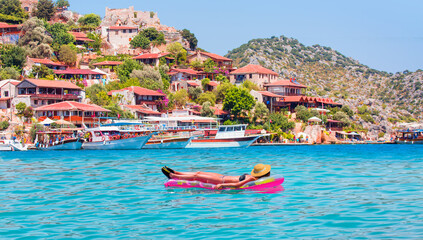 Fototapeta premium Girl in bikini lying on air bed - Kekova island (Ucagiz - Kale) - Antalya, Turkey