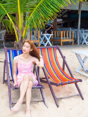 young girl sitting on the beach. by sea, tropical beach. summer style.