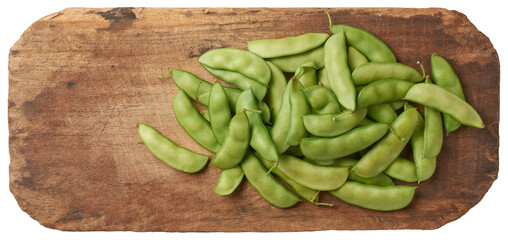 pile of pea pods on cutting board, type of legume that is widely cultivated for its nutritious seeds and pods, freshly harvested vegetable isolated on white background, taken from above and copy space