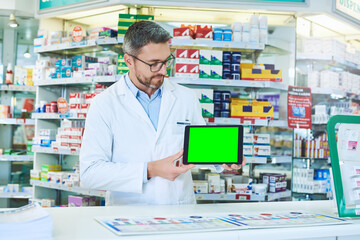 Man, pharmacist and tablet with green screen with healthcare, store and mockup with pharmaceutical promo on app. Mature pharma expert, digital touchscreen and space with chromakey for mock up in shop