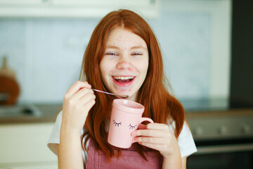 face of a teenage girl with pimples, acne on the skin, portrait of a cool happy teen girl drink a...