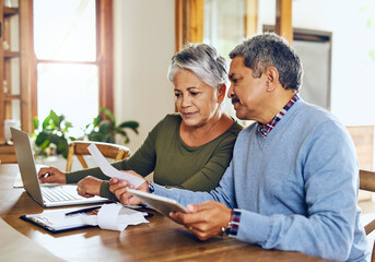Senior couple, budget planning and health insurance checklist with computer at home. Documents,...