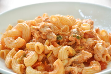 stir fried rigatoni pasta with chicken dressing ketchup on plate