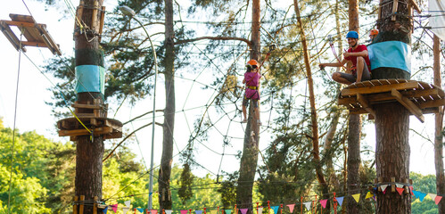 Smiling little girl on the playground, climbing rope net