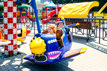 children on the airplane carousel attraction