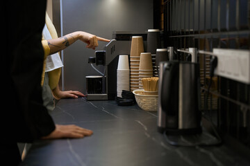 Woman showing how to make coffee in the office