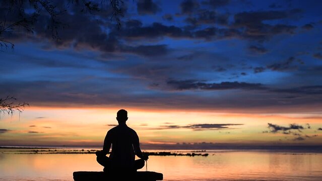 meditation on the beads closeup, meeting the sunrise on the seashore, meditation in the lotus position at sunrise and sunset