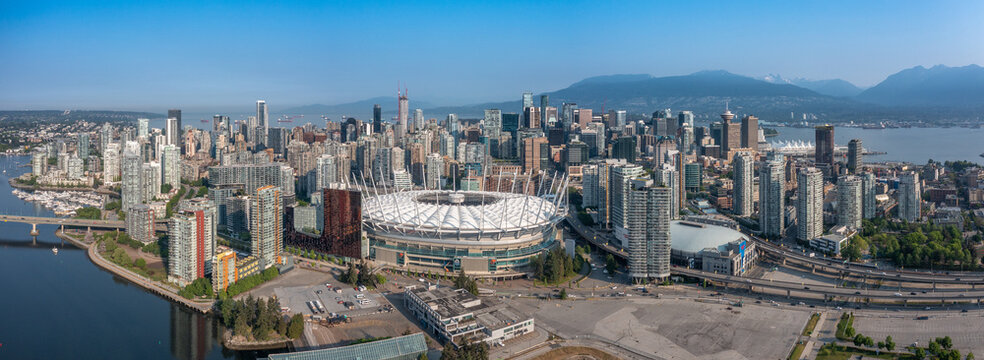 Vancouver, BC, Canada, aerial panoramic city view of famous False Creek in Vancouver downtown with Cambie Bridge and BC Place Stadium in front and Vancouver Skyline in the background 