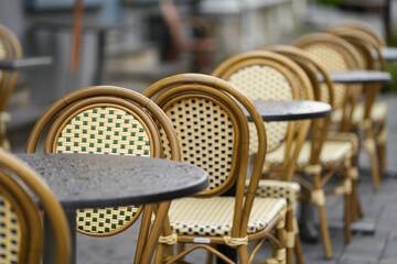 the tables and chairs of a terrace. detail. the exterior of a restaurant.