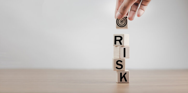 Wooden blocks with the word Risk and a team with a leader. Business concept of teamwork, Financial Crisis, Economic, Business risk management concept. Business planning. Risk assessment. Forecast.