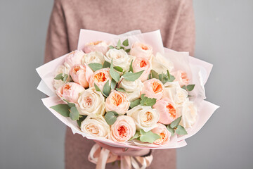 Large Beautiful bouquet of mixed flowers in woman hand. Floral shop concept . Beautiful fresh cut bouquet. Flowers delivery