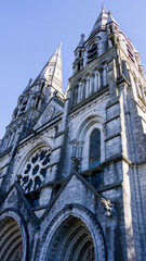 The tall Gothic spire of an Anglican church in Cork, Ireland. Neo-Gothic architecture. Cathedral Church of St Fin Barre, Cork - Ireland’s Iconic Buildings.