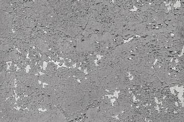Сoncrete wall with old cracked, peeling flaking gray paint. Weathered rough painted surface with patterns of cracks and peeling, grunge, aged texture. Background, backdrop, wallpaper, design element