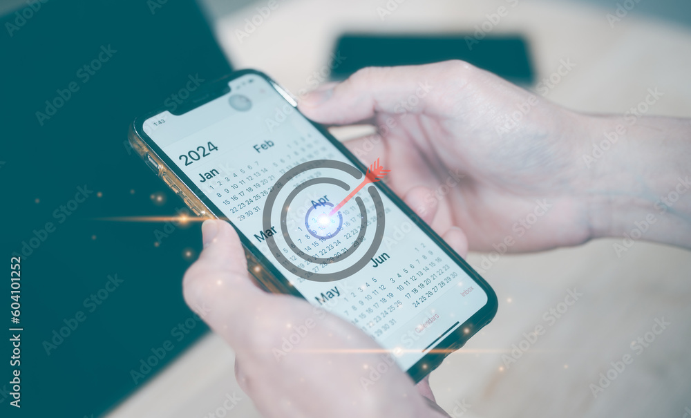 Poster concept of financial target planning and reminder for 2024. man using smartphone working with calend