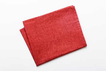 top view with red empty kitchen napkin isolated on table background. Folded cloth for mockup with...