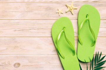 Flat lay composition with flip flops and seashell on colored background. Space for text top view