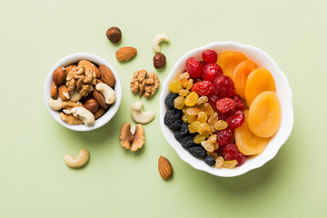 healthy snack: mixed nuts and dried fruits in bowl on table background, almond, pineapple, cranberry, cherry, apricot, cashew
