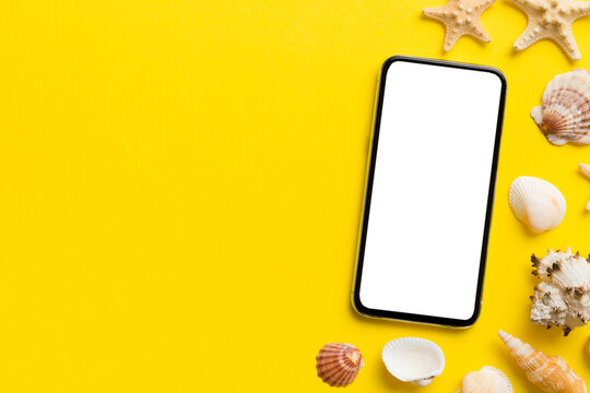 Flat lay composition with Phone and beach accessories on colored background. Smartphone with blank screen mock up with copy space - Powered by Adobe