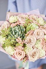 Beautiful bouquet of mixed flowers in woman hand. Floral shop concept . Beautiful fresh cut bouquet. Flowers delivery