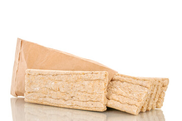 Several rye crispbreads in a paper bag, macro, isolated on a white background.