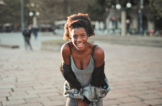 portrait of a young smiling  woman in the street