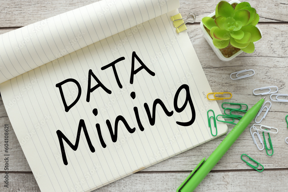 Poster top view of notebook with text data mining near potted plant
