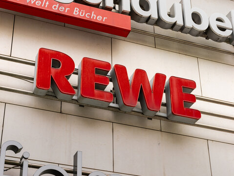 DRESDEN, GERMANY - 16. May 2023: Rewe logo of the supermarket on a building facade. German grocery store and retailer. Sign as advertisement on an exterior.