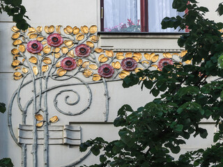 Details a house facade in Prague, which shows charateristics of Art Nouveau Architecture school from 1890-1920s