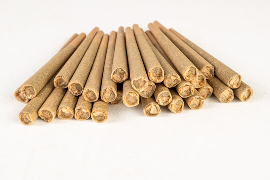Stack of marijuana joint pre-rolled cone paper on white background, roll paper cannabis