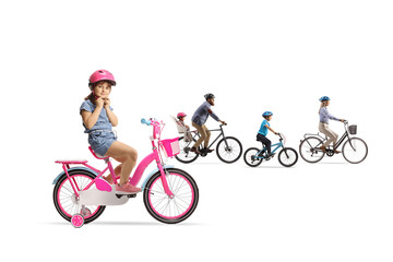 Fototapeta premium Mother and father with children riding bicycles and a girl putting on a helmet
