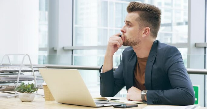 Serious man, thinking and writing notes of business research, planning proposal or ideas at office desk. Focused male worker, notebook and question of decision, choice or review information at laptop