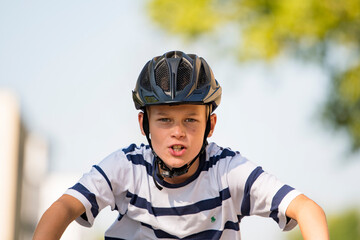 Fototapeta na wymiar child on bicycle with helmet very fast in a race