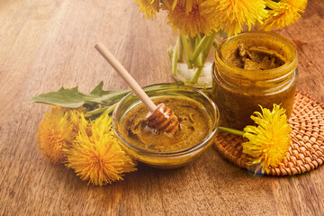 Honey or jam of dandelions in the jar with fresh flowers