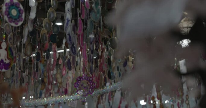 Crystals and quarts decorations hanging from ceiling in shop - close up