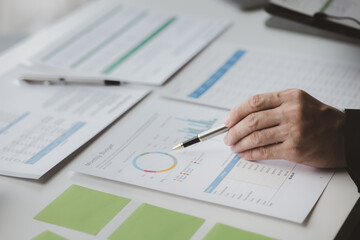Executives and managers are meeting in a conference room, on the table there are some documents about the company's finances, managers are discussing financial information with the management.