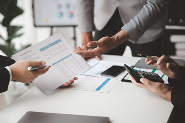 Meeting room atmosphere, business people meeting together on finance topics, they are working together to plan and solve corporate finance issues. Concept of business administration and finance.