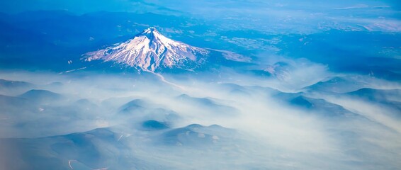 An aerial shot of Mt Hood with fog laying in the valleys surrounding the mountain, near Portland,...