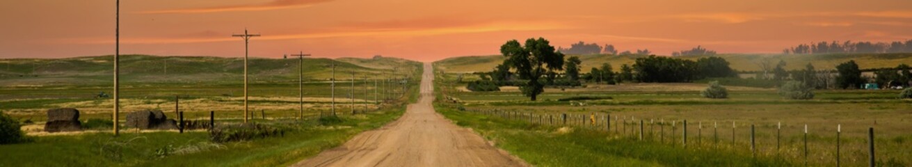 Fototapeta na wymiar a county gravel road runs through farm land in north eastern Colorado east of Sterling