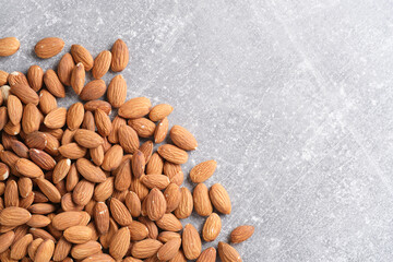 Lot almonds gray concrete background.