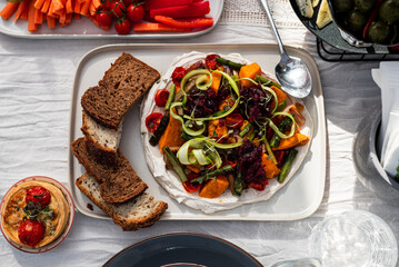 Beautifully laid out dishes on the table, sausage, meat, salt, bread