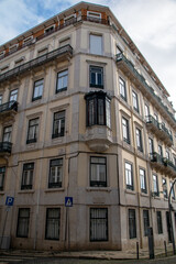 Fototapeta na wymiar Facade of an old house with red bay window, European historical buildings, Lisbon, Portugal