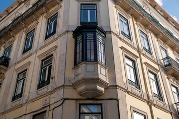 Facade of an old house with red bay window, European historical buildings, Lisbon, Portugal