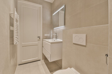 a bathroom with a toilet, sink and mirror on the wall next to each other items in the room is very clean